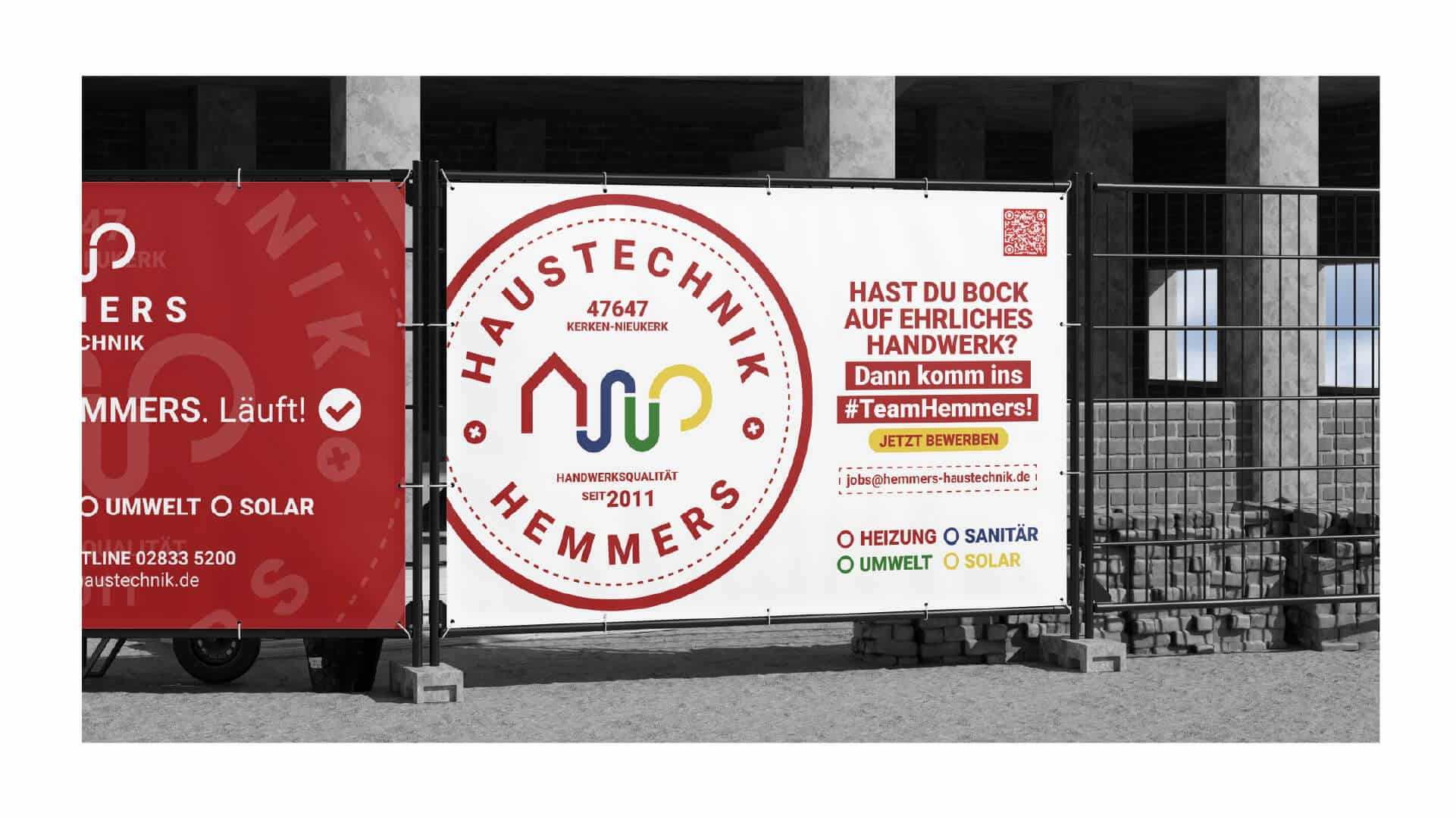 Werbebanner von Hemmers Haustechnik an einem Zaun